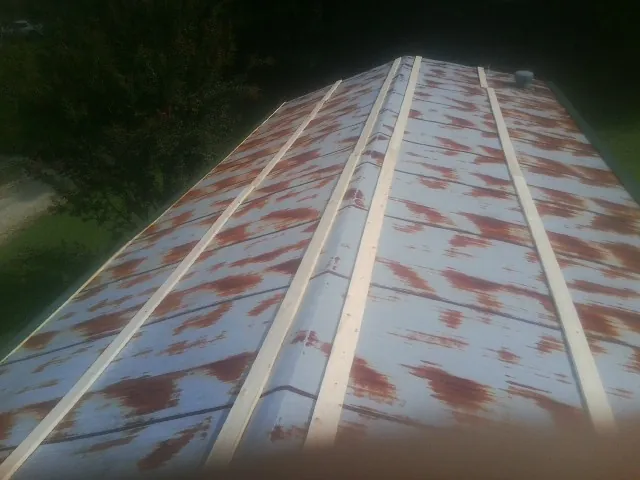 Rusted metal roof panels with new wood purlins before replacement — Storm Damage Roof Repair in Scarborough by Roofing Brothers