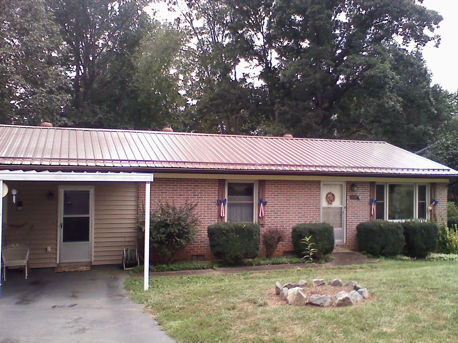 Bronze metal roof and carport on a brick ranch home — Roof Repair work by our crew in Scarborough
